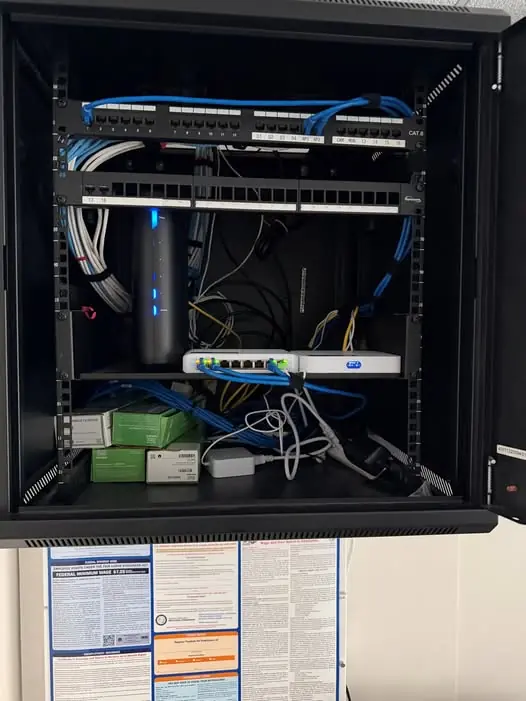 Business network rack with switches, patch panels, and routing equipment